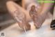 A woman is washing her feet in a bathtub.