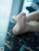 A close up of a person's bare feet on a table.