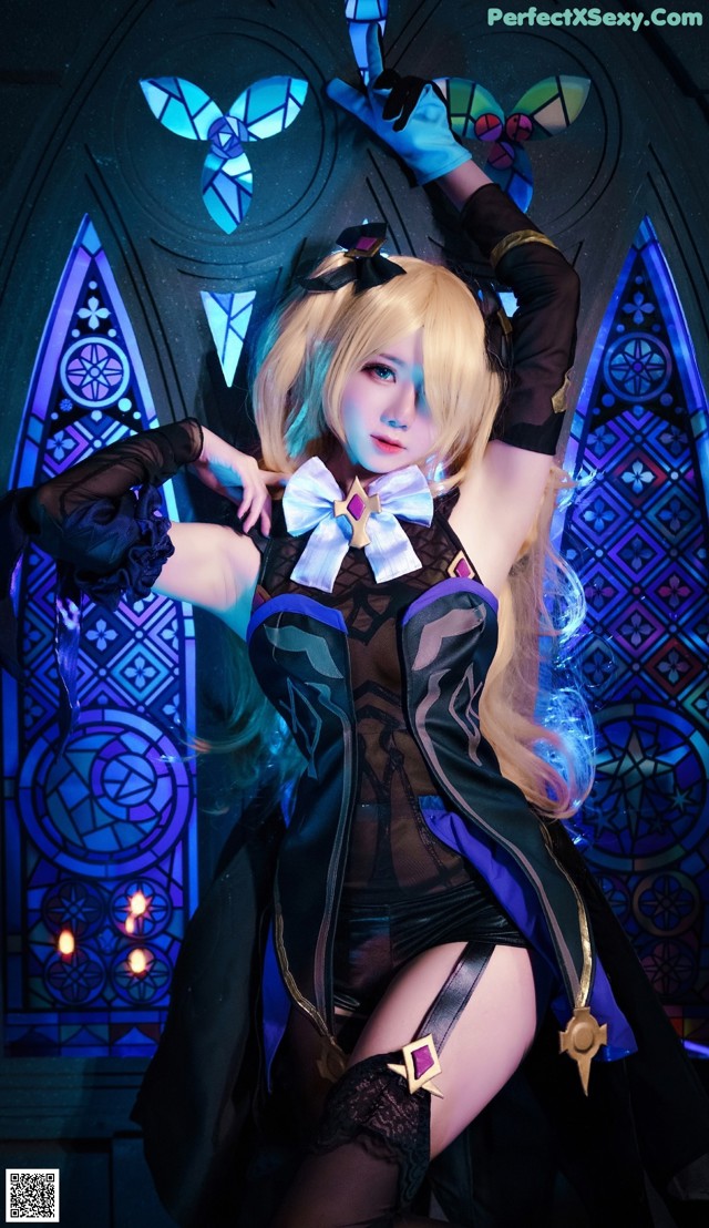 A woman in a black and blue outfit posing for a picture.